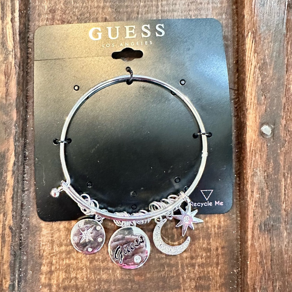 Guess silver tone metal bracelet with charms moon star logo NWT